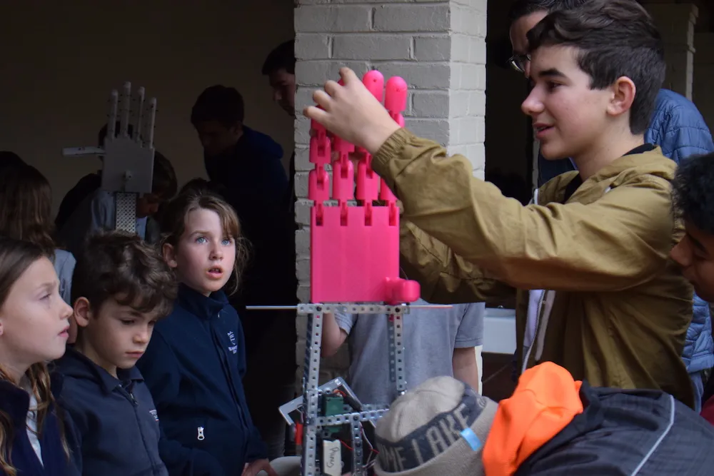 providence students showcasing a robotic hand.