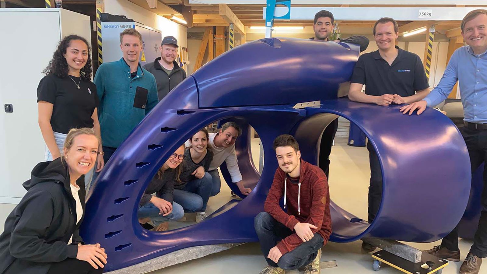 Energyminer team showcasing the housing of the Energyfish