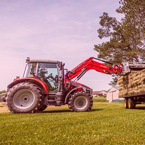 Norden Mfg tractor loading hay onto a trailer