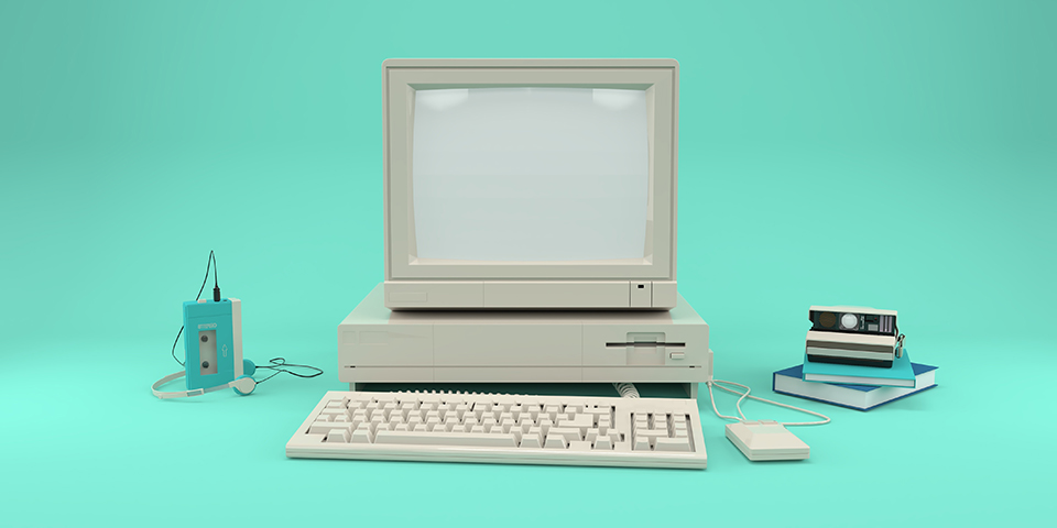 Stock image of an old desktop and cassette player.