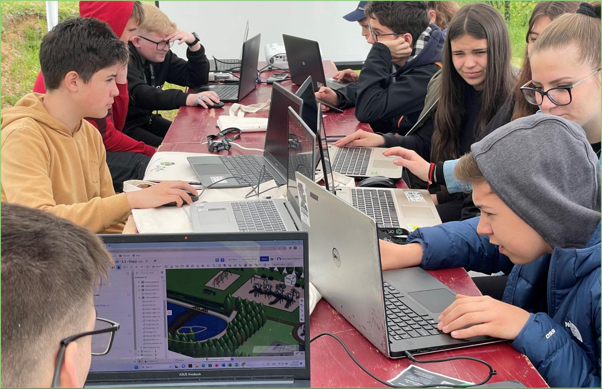 Students on laptops outside