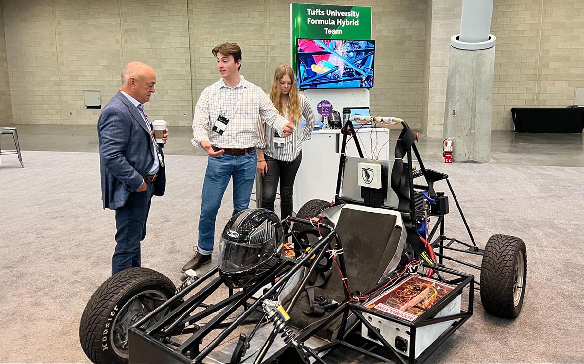 tufts students with an FSAE car