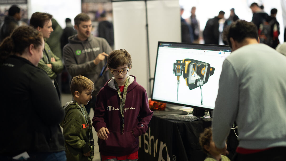 the Onshape team at a booth during an event