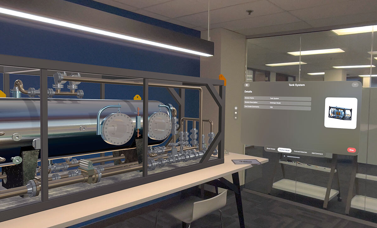 Viewed through the lens of Apple Vision Pro, a wearable spatial computer, a digital 3D CAD model of an oil refinery tank sits on top of a conference room table.