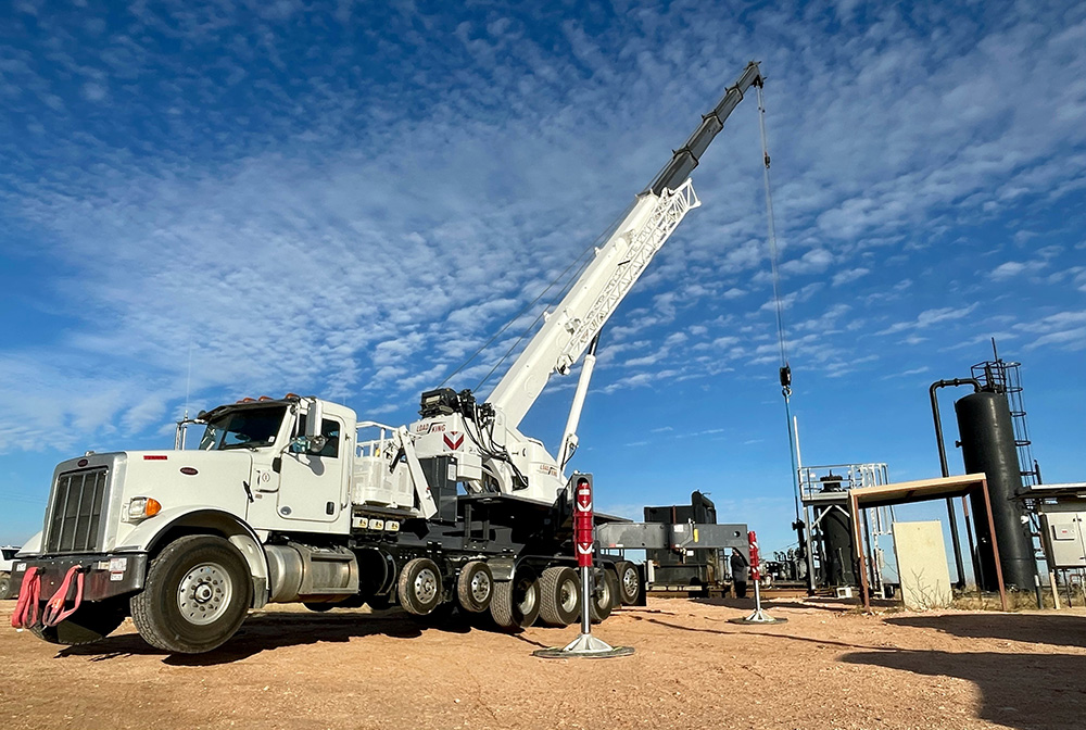 Truck with extended boom working in oil refinery