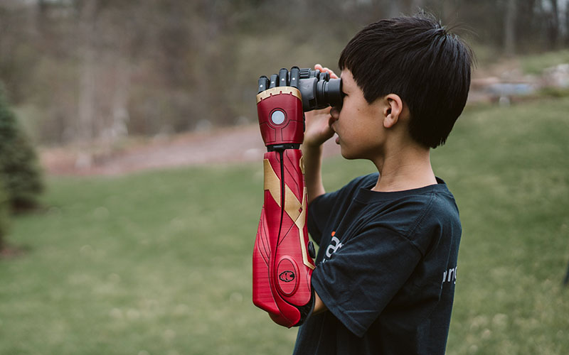 Child using a Hero Arm customized to Iron Man styling