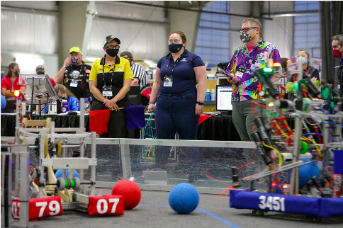 McKenzie at a robotics event standing.